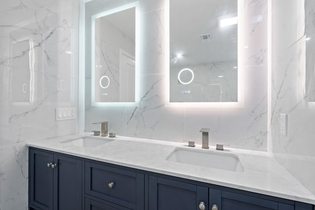 bathroom with vanity and tile walls