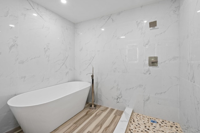 bathroom featuring hardwood / wood-style floors and separate shower and tub