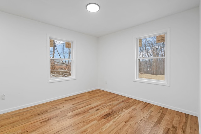 spare room with light hardwood / wood-style flooring