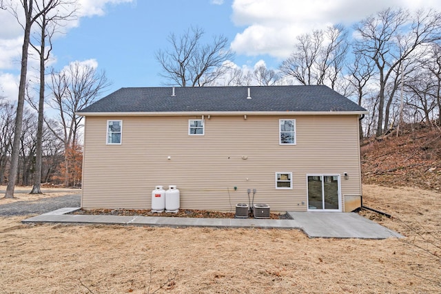 rear view of property featuring a patio and central AC