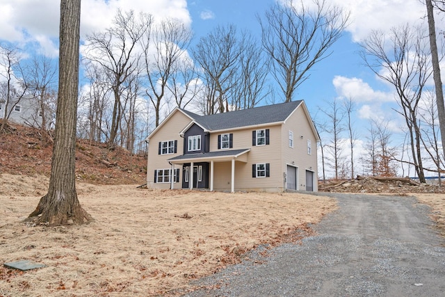 front of property with covered porch and a garage