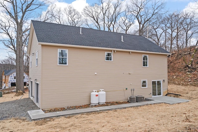 back of house featuring a garage