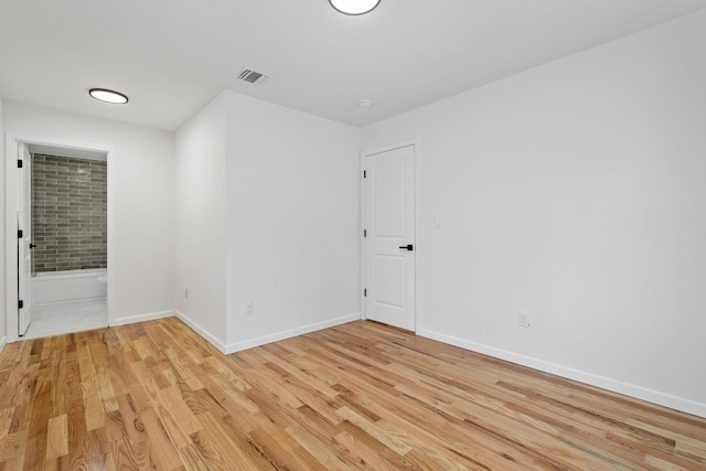 spare room with light wood-type flooring