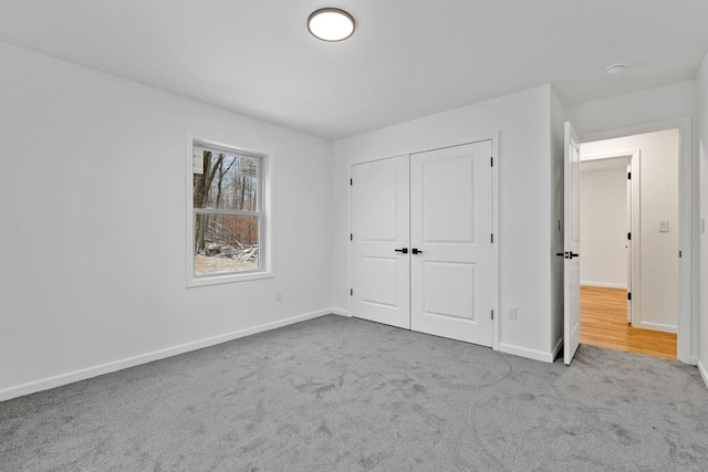 unfurnished bedroom featuring carpet floors and a closet