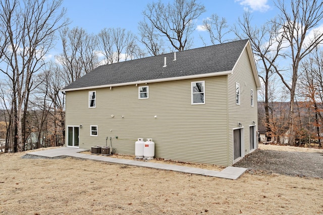 rear view of property featuring a garage