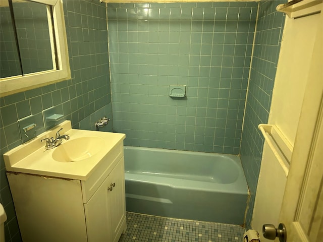 bathroom featuring tile patterned floors, vanity, decorative backsplash, tile walls, and  shower combination