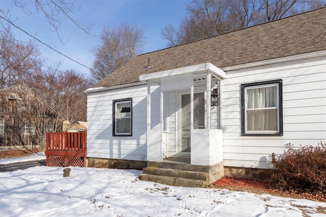 view of snow covered property entrance