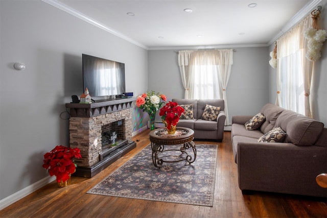 living room featuring hardwood / wood-style flooring, ornamental molding, and a fireplace