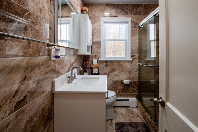 bathroom featuring baseboard heating, vanity, a shower with shower door, and toilet