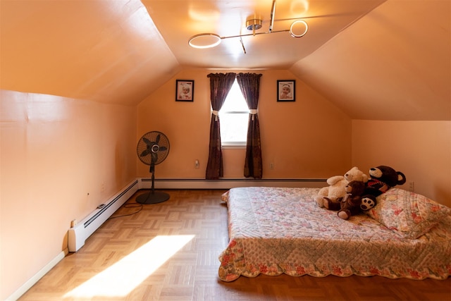 unfurnished bedroom with light parquet flooring, a baseboard heating unit, and vaulted ceiling