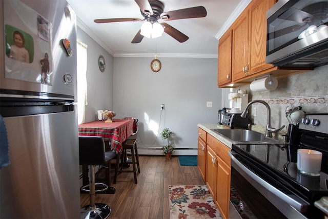 kitchen with sink, dark hardwood / wood-style floors, crown molding, decorative backsplash, and appliances with stainless steel finishes