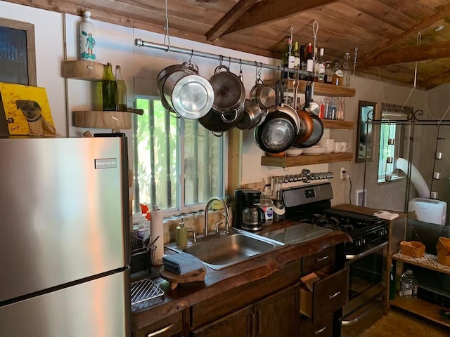 kitchen with appliances with stainless steel finishes, wood ceiling, and sink