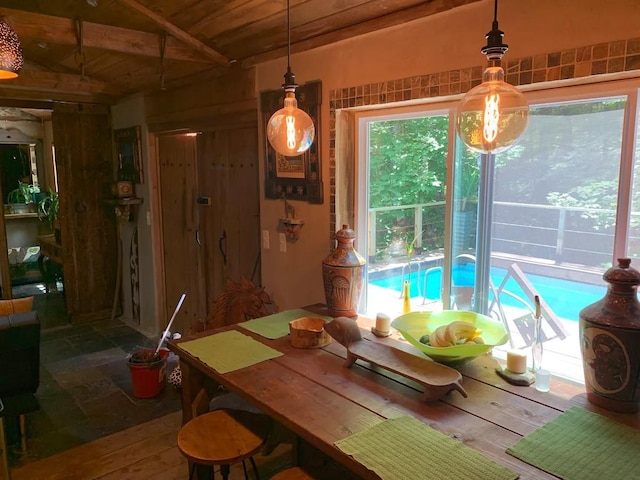 dining room with wooden ceiling and a healthy amount of sunlight