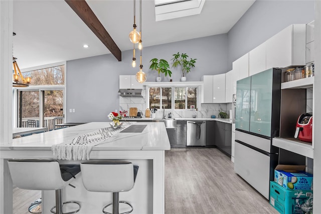 kitchen with white cabinets, stainless steel dishwasher, beamed ceiling, decorative light fixtures, and extractor fan