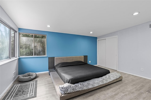 bedroom featuring light wood-type flooring and a closet