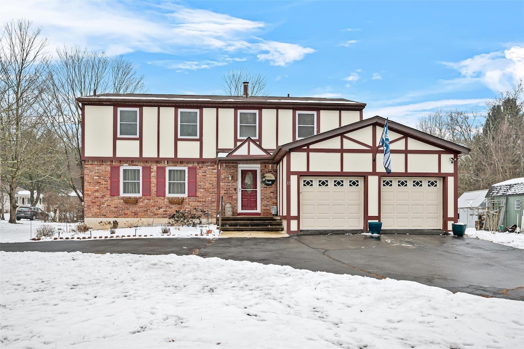 tudor-style house featuring a garage