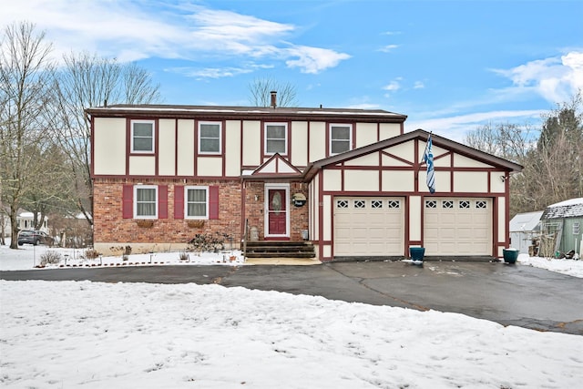 tudor-style house featuring a garage