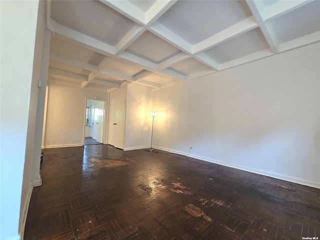 unfurnished room with dark parquet floors, beam ceiling, and coffered ceiling