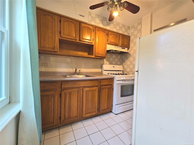 kitchen with white appliances, tasteful backsplash, ceiling fan, and sink