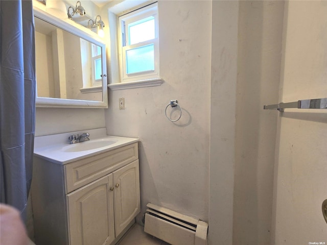 bathroom with vanity and baseboard heating