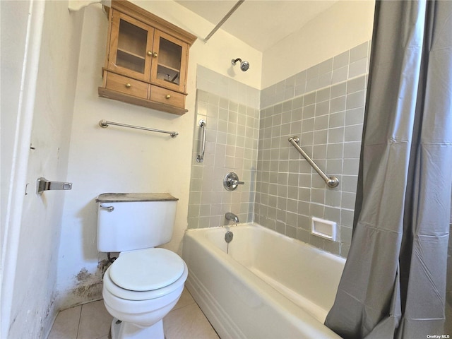 bathroom with toilet, tile patterned floors, and shower / bath combo with shower curtain