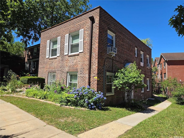 view of home's exterior featuring a lawn and cooling unit