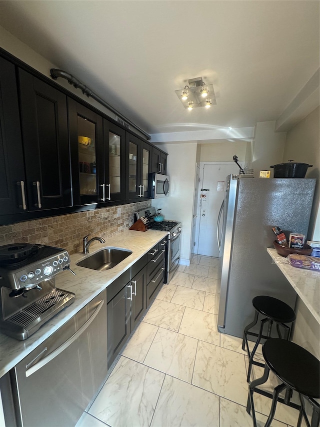 kitchen with backsplash, sink, and stainless steel appliances