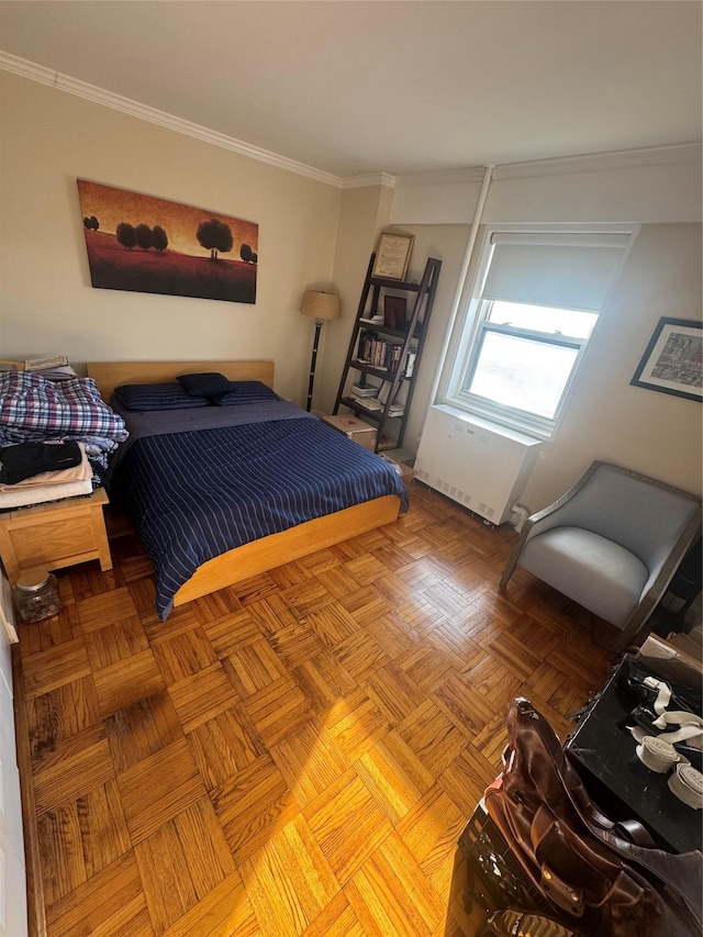 bedroom with parquet floors and crown molding