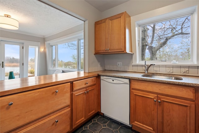 kitchen featuring dishwasher, sink, kitchen peninsula, a textured ceiling, and dark tile patterned flooring