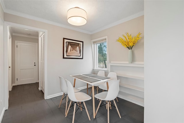 dining space featuring ornamental molding and a textured ceiling