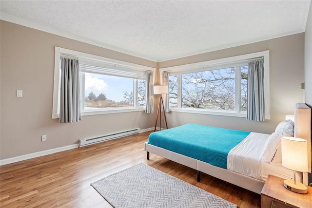 bedroom featuring ornamental molding, a textured ceiling, hardwood / wood-style flooring, and a baseboard heating unit