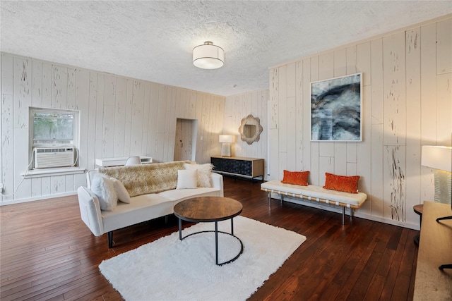 living room with dark hardwood / wood-style flooring, cooling unit, and wooden walls