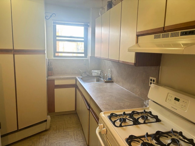 kitchen with white appliances, tasteful backsplash, and sink