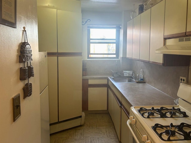 kitchen with white range with gas stovetop and sink