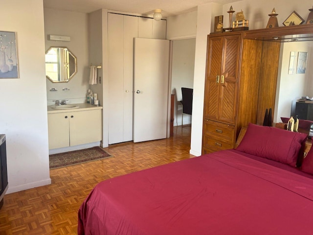 bedroom with dark parquet floors and sink