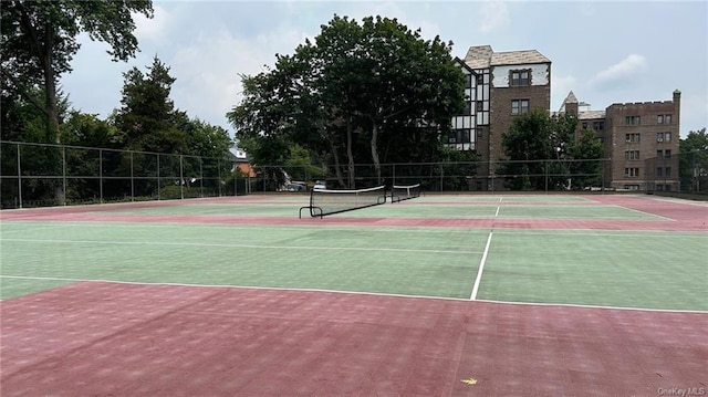 view of tennis court featuring basketball hoop