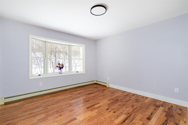 spare room featuring light hardwood / wood-style floors and a baseboard radiator