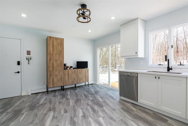 kitchen featuring dishwasher, a baseboard radiator, white cabinetry, and sink