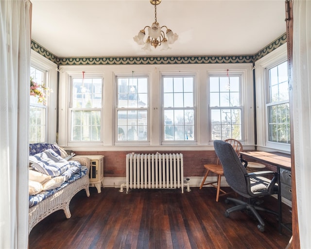 office space featuring radiator heating unit, dark hardwood / wood-style floors, and an inviting chandelier