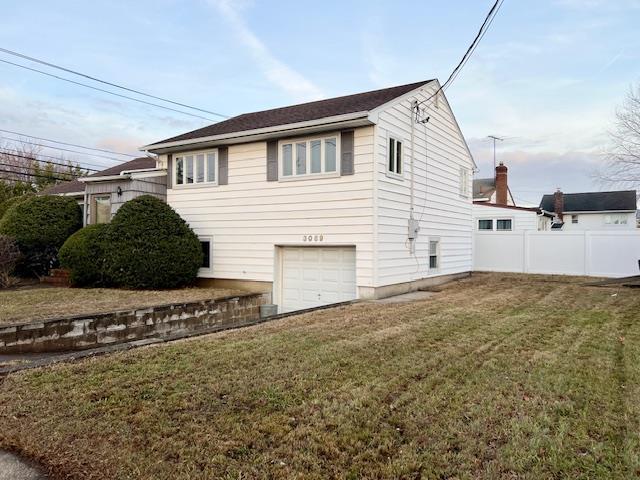 view of side of property with a garage and a yard