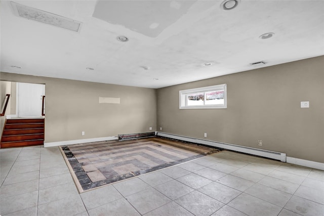 empty room featuring a baseboard radiator and light tile patterned flooring