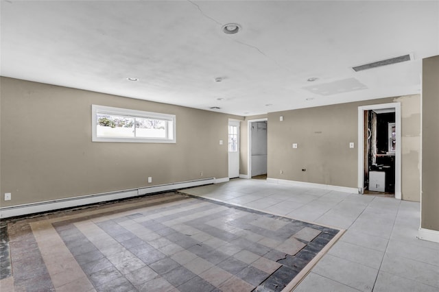 tiled empty room with a baseboard radiator