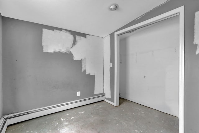 unfurnished bedroom with a baseboard radiator and a closet