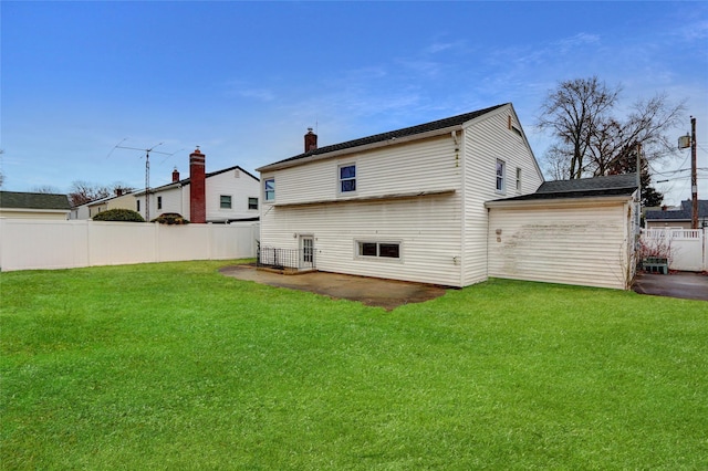 back of house featuring a yard and a patio