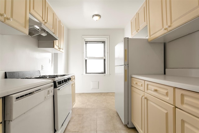 kitchen featuring light tile patterned floors and white appliances