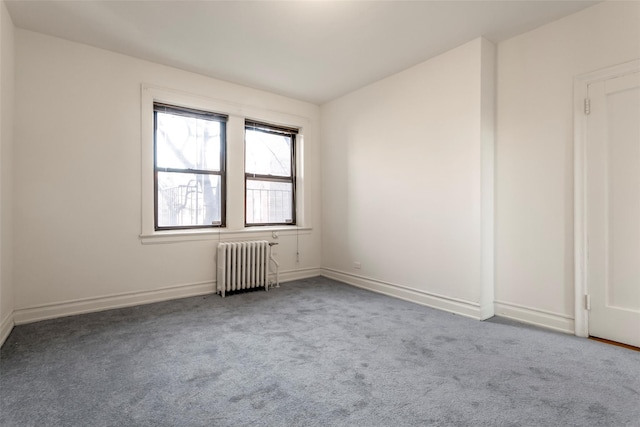 unfurnished room featuring carpet flooring and radiator