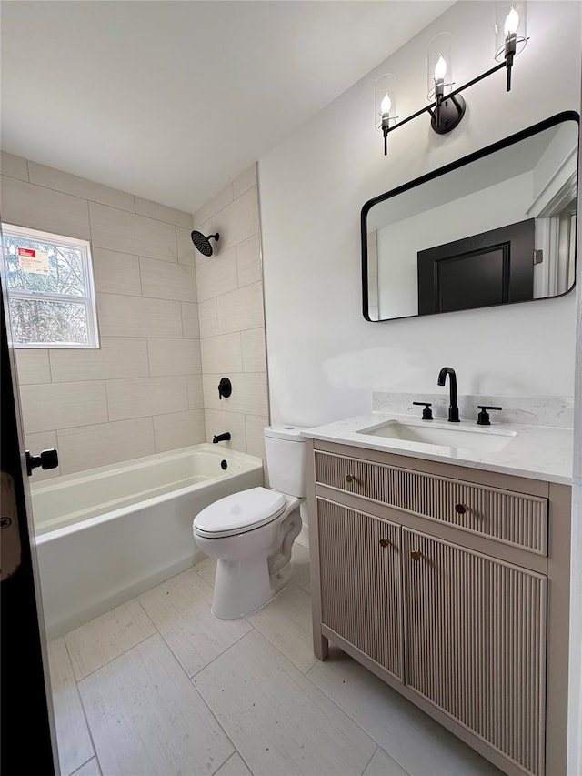 full bathroom featuring toilet, vanity, and tiled shower / bath combo