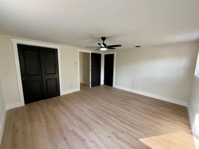 unfurnished bedroom with light hardwood / wood-style flooring and ceiling fan