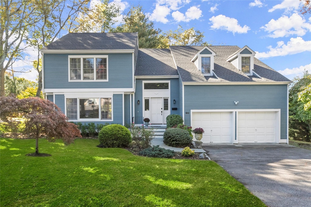 view of front facade with a garage and a front lawn