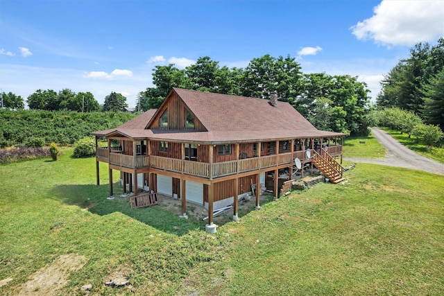 rear view of property featuring a lawn and a deck